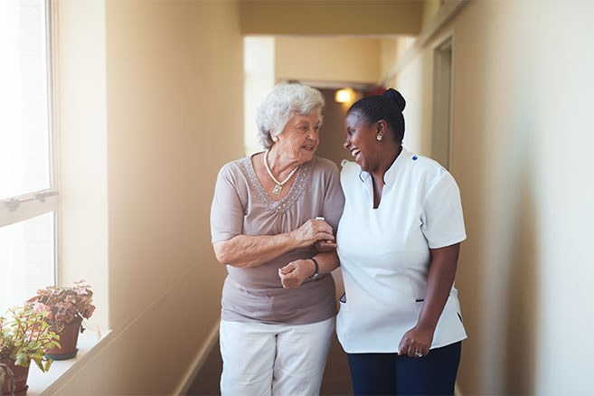 Happy Female Caregiver And Senior